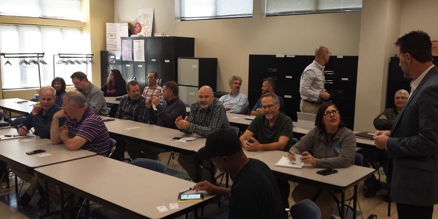 Employees in conference with their pens and notepads