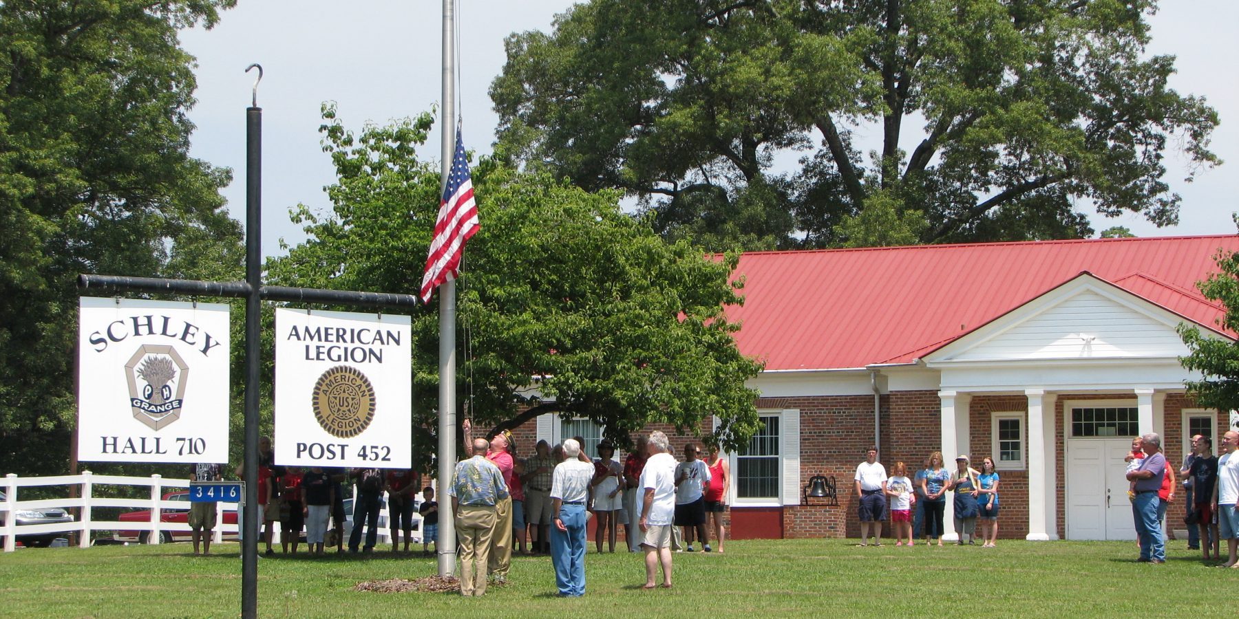people saluting the American Flag in Schley Hall 710