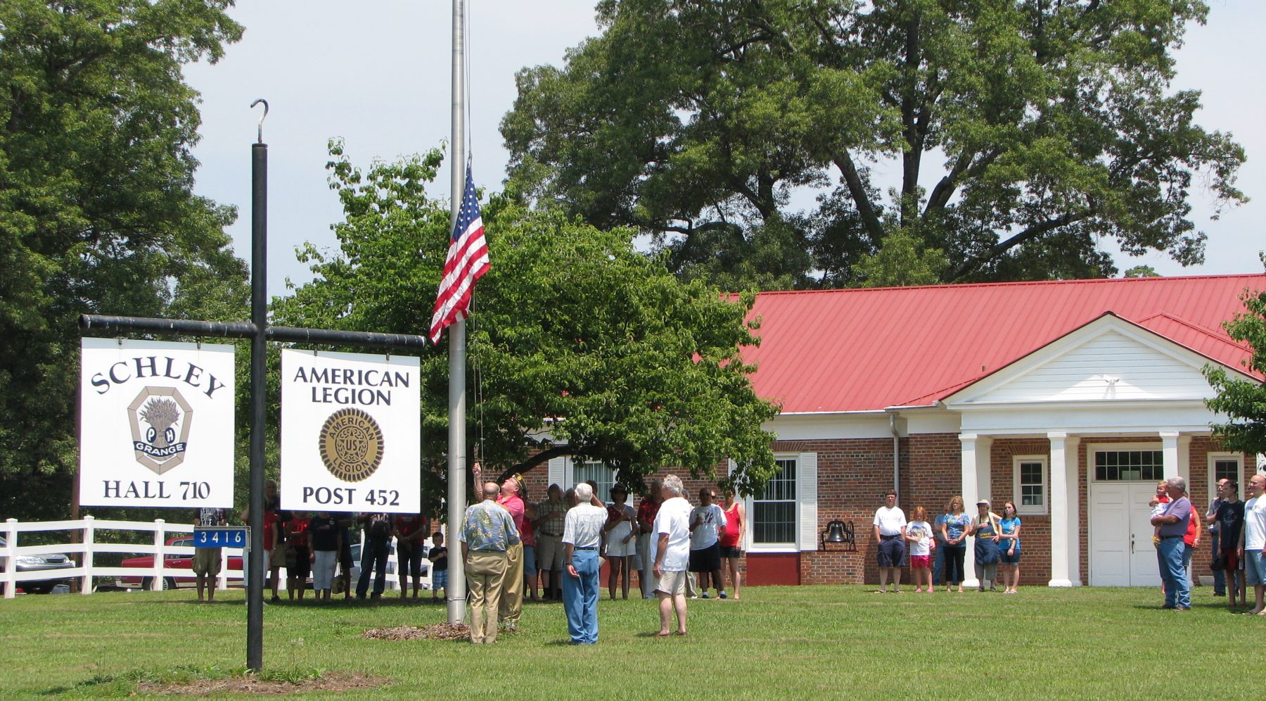 people saluting the American Flag in Schley Hall 710
