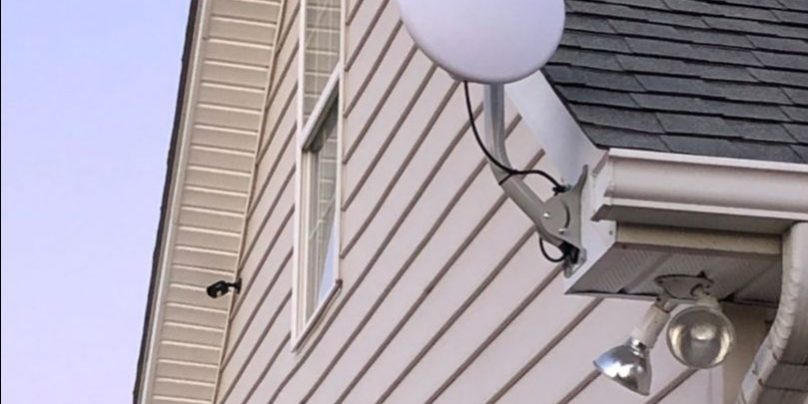 Circle dish attached to roof of house