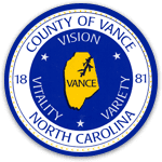 Vance County Emblem blue lettering yellow county picture in center