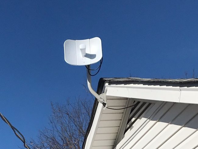 Dish with 3 panels attached to white house